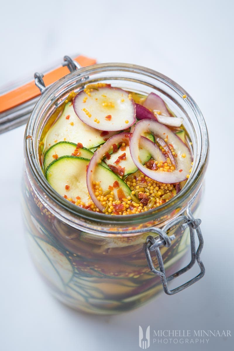 Pickled zucchini in a glass jar. 