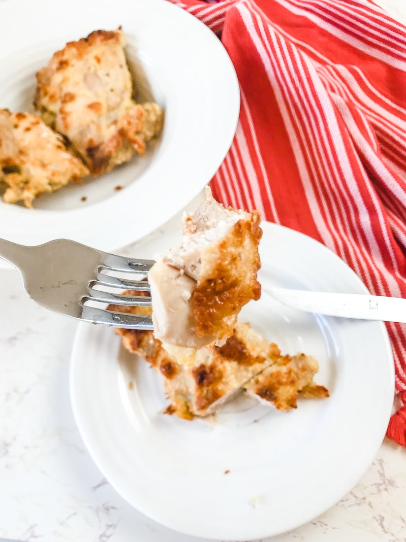 A bite of crispy baked chicken on a fork.