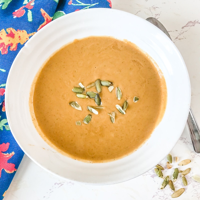 Close up of easy pumpkin soup in a white bowl.