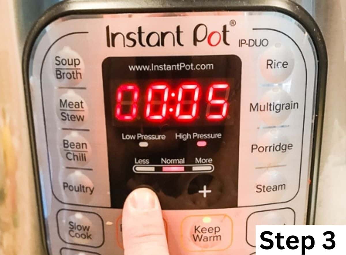 A finger pointing at the front of an instant pot set to 5 minutes.
