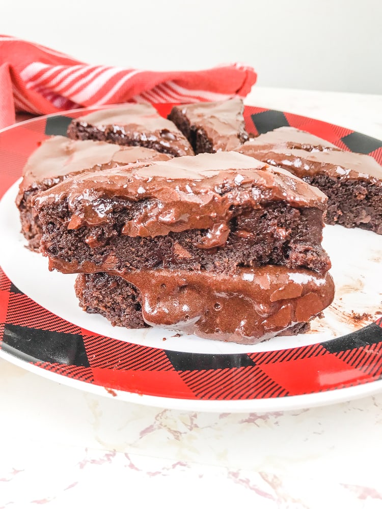 A stack of two instant pot brownies on a red and black plate.