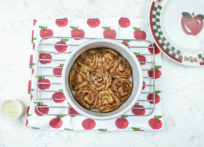 A pan of instant pot pillsbury cinnamon rolls on a cooling wrack.