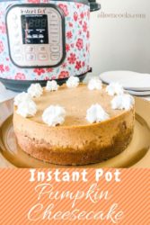 A pumpkin cheesecake topped with dollops of whipped cream in front of an instant pot.