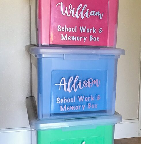 Three school memory boxes stacked up against a wall.