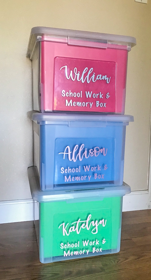 Three school memory boxes stacked up against a wall.