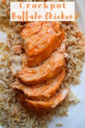 Four slices of crockpot buffalo chicken on top of a bed of brown rice.