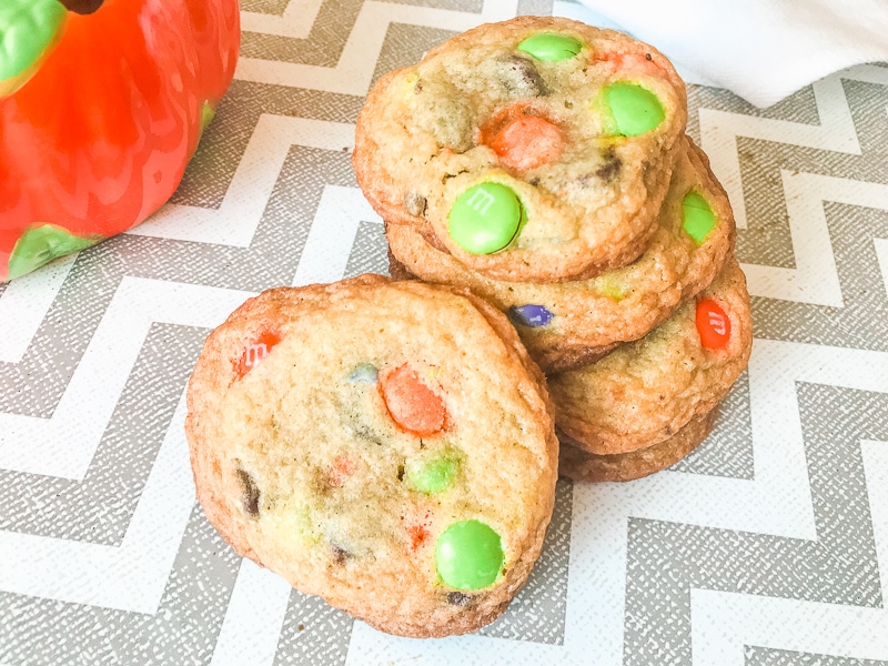 Halloween chocolate chip cookies stacked up over a zig zag tabletop.