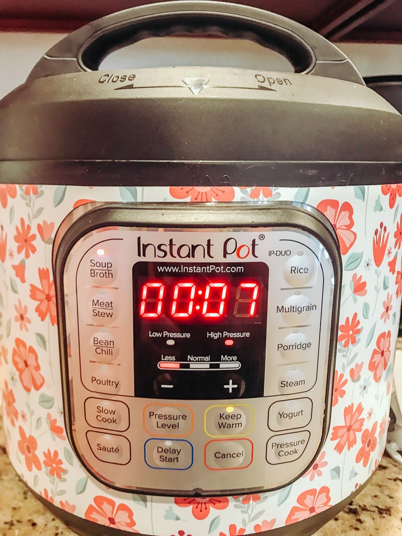 An instant pot set to 7 minutes for chicken vegetable soup.