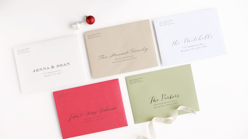 Colorful holiday card envelopes with addresses printed on them.