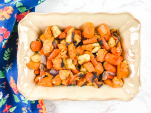 Overhead shot of roasted root vegetables recipe in rectangular baking dish.
