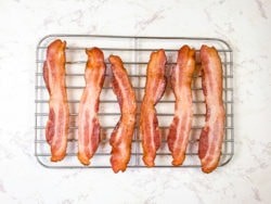 Air fryer bacon on a cooling rack.