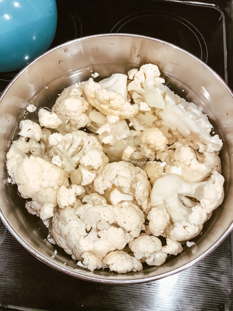 A pot of salted water filled with cauliflower.