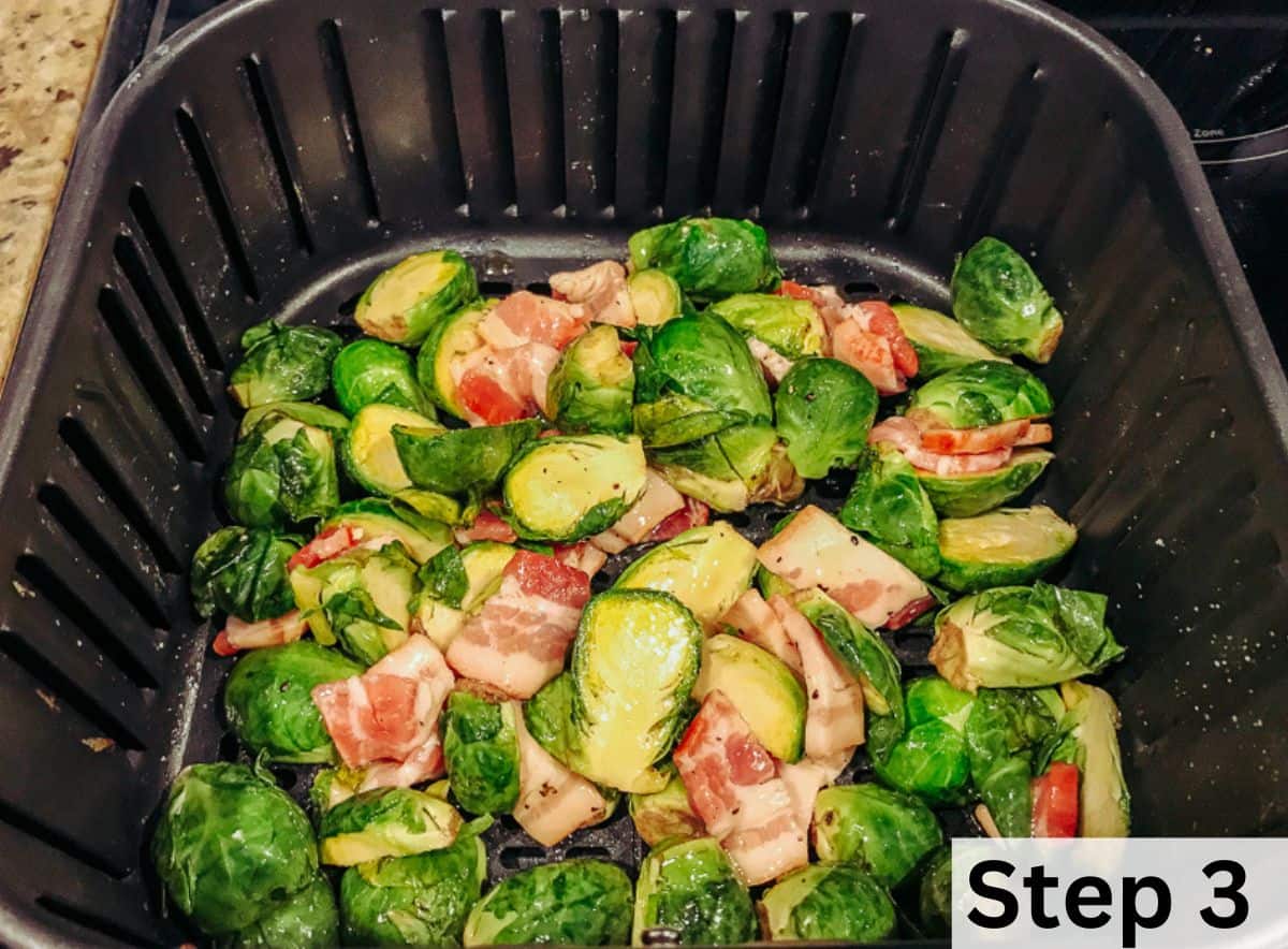Brussels sprouts and bacon combined inside the basket of an air fryer.