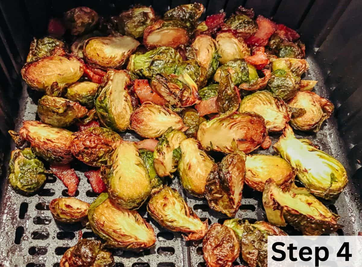 Charred Brussels sprouts and bacon inside an air fryer.