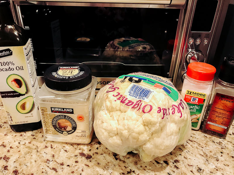 Ingredients for air fryer cauliflower in front of air fryer toaster oven.