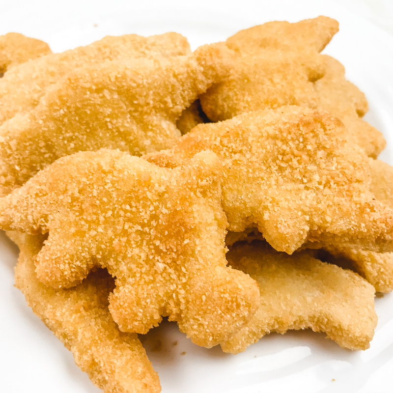 Close up of Dino-shaped air fryer frozen chicken nuggets.