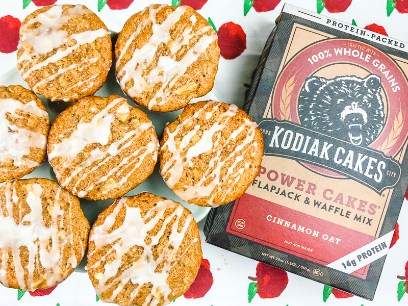 A box of Kodiak Cakes mix next to 7 glazed apple cinnamon muffins.