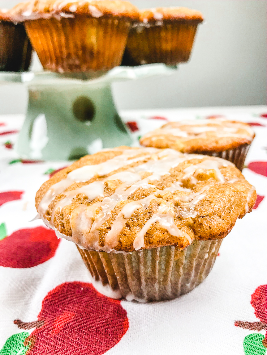 A side view of apple cinnamon muffins with icing.