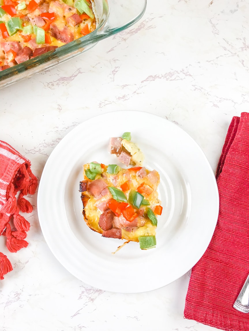 A serving of breakfast casserole on a white plate.