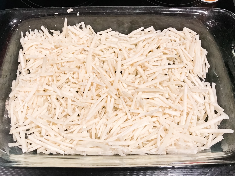 Hash browns in a large casserole dish.