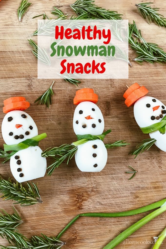 Three snowman snacks on a cutting board next to each other with words "healthy snowman snacks"