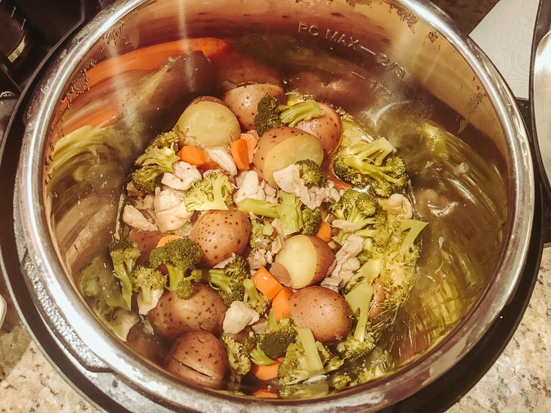 Cooked chicken and vegetables inside instant pot.