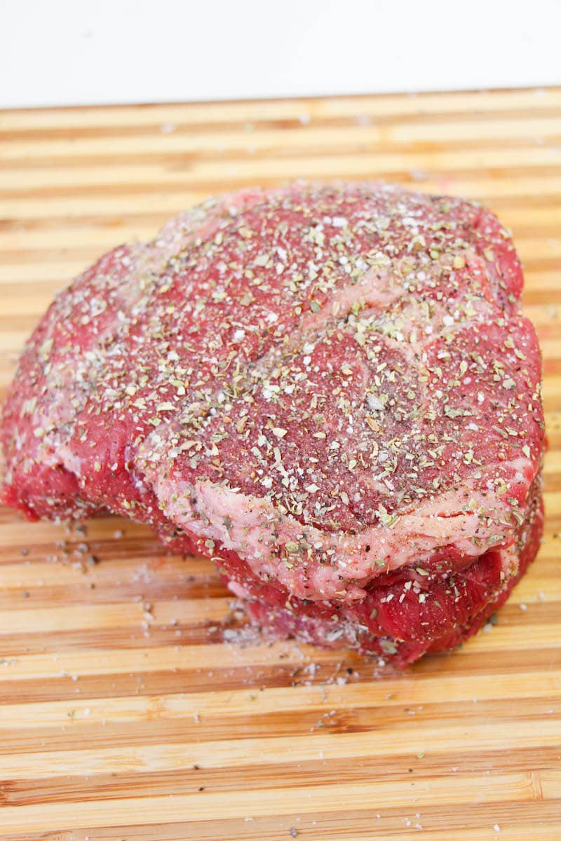 Chuck roast sprinkled with seasonings.