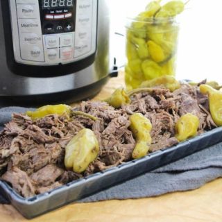 A platter of Italian beef in front of instant pot.