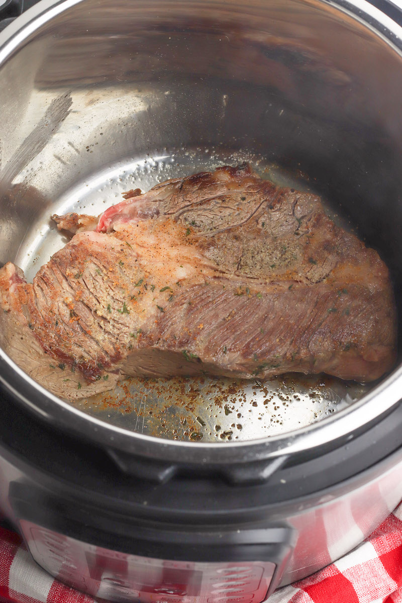Meat being seared inside instant pot.