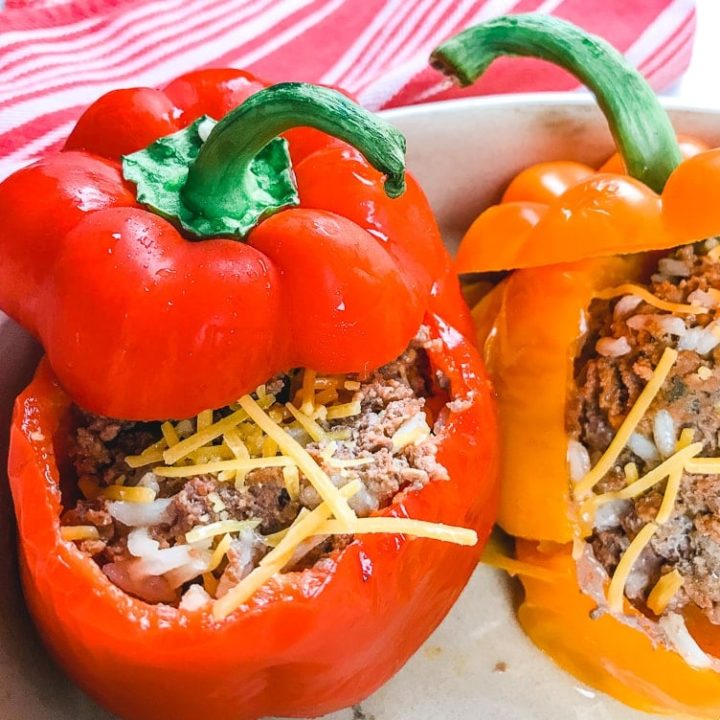 A red bell pepper stuffed with cooked ground beef and topped with cheese.