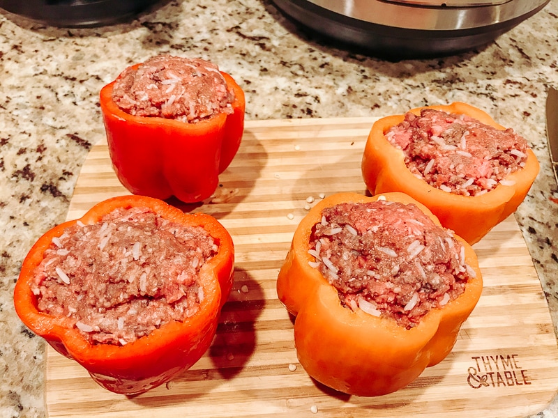 Red and orange bell peppers stuffed with ground beef.