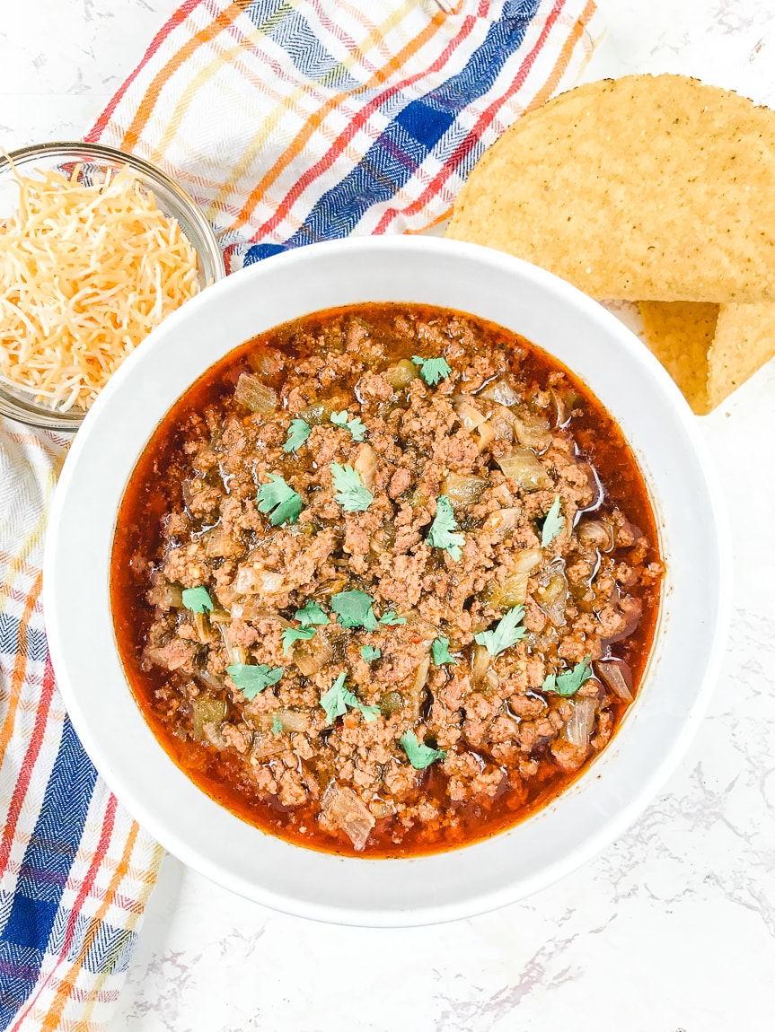 A bowl of instant pot taco beef on top of a striped towel.