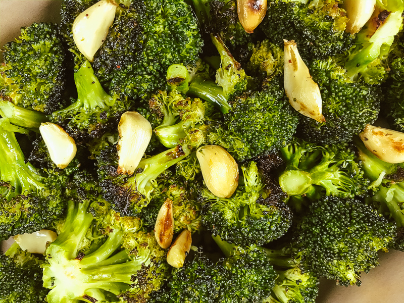 Close up of roasted broccoli and garlic.