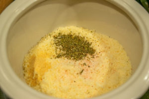 Bowl of parmesan cheese with spices.