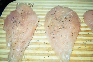 Chicken seasoned with salt and pepper.
