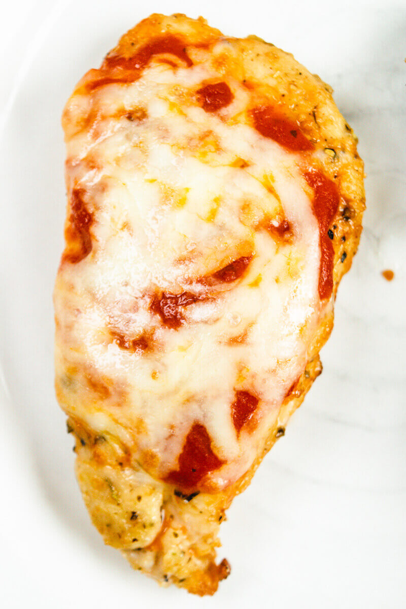 Chicken parmesan on a white plate.