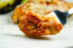 Close up of bite of chicken parmesan.