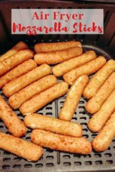 Frozen mozzarella sticks in an air fryer basket.
