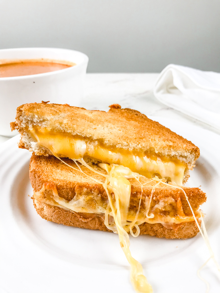 Close up of air fried grilled cheese cut in half.