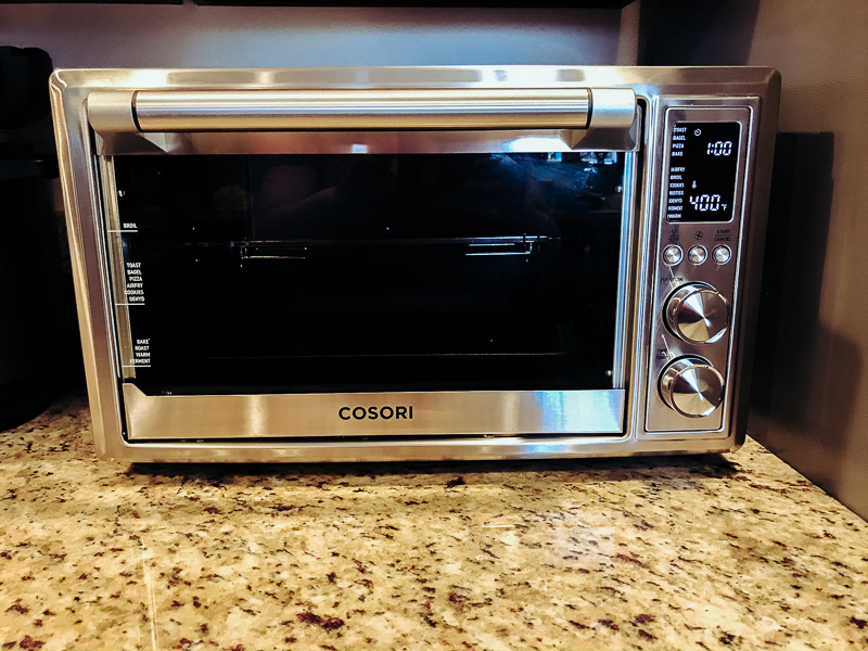Cosori air fryer toaster oven on countertop.