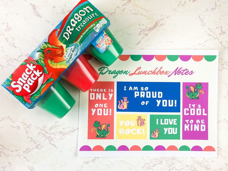 Dragon-themed printable lunchbox notes next to dragon snack pack package.