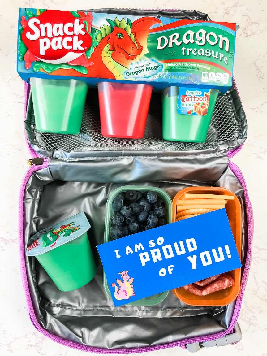 Package of snack packs next to lunchbox with blue lunch box note.