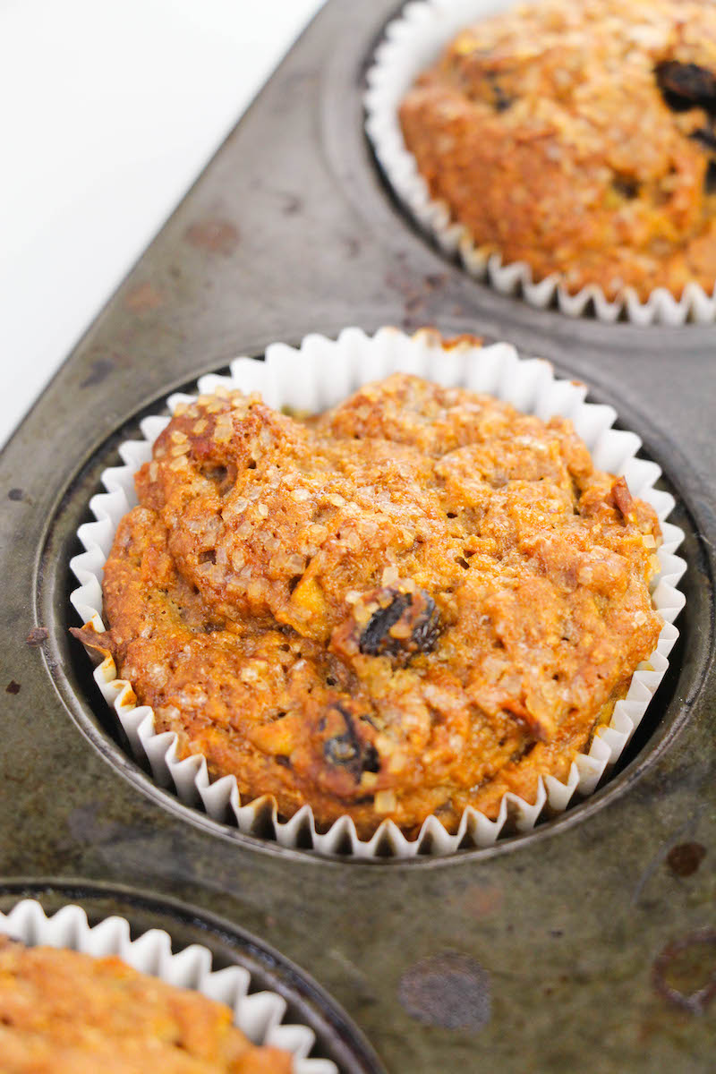 Close up of morning glory muffin inside baking tin.