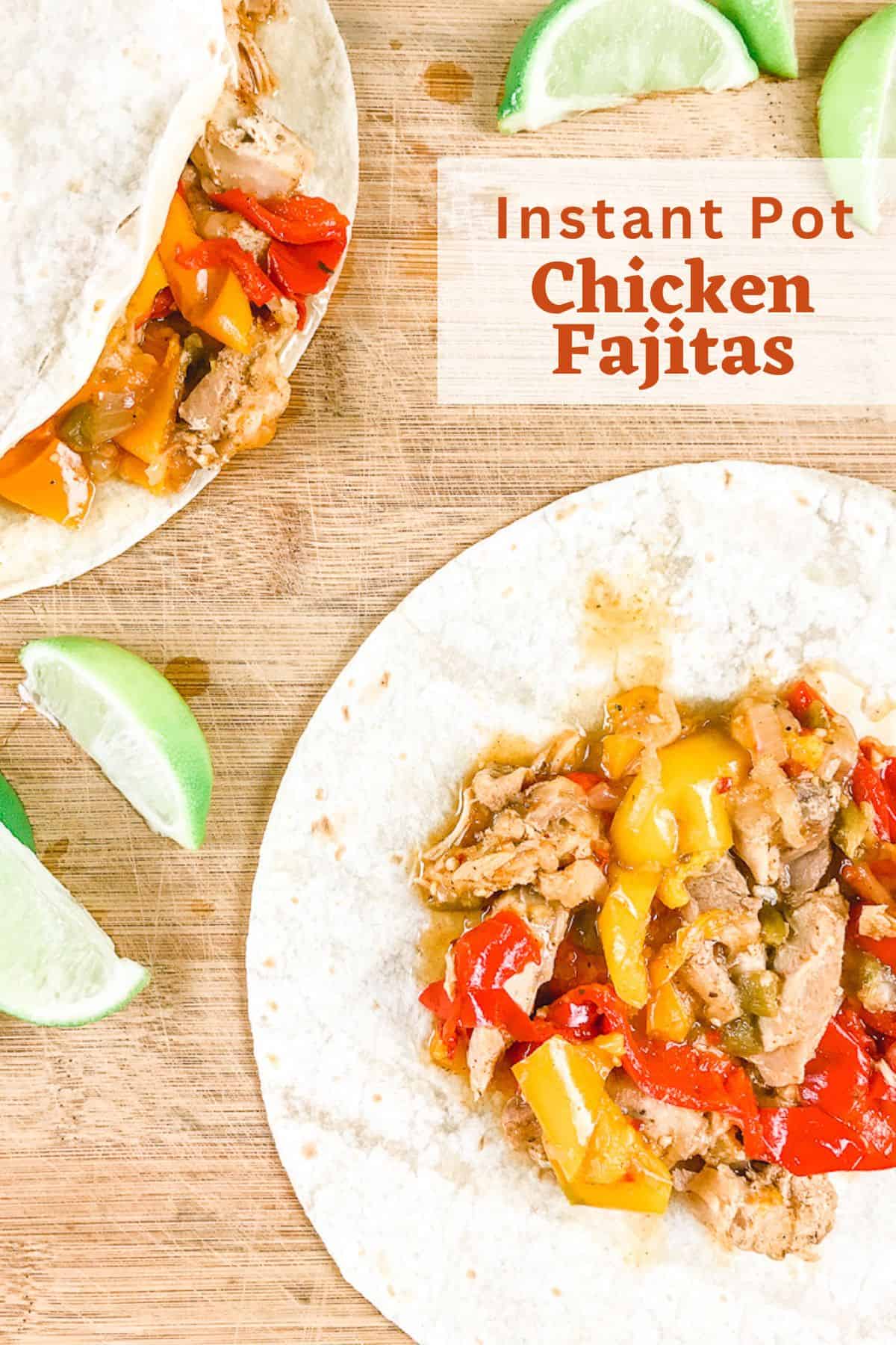 A wooden cutting board with two chicken fajitas and lime wedges.