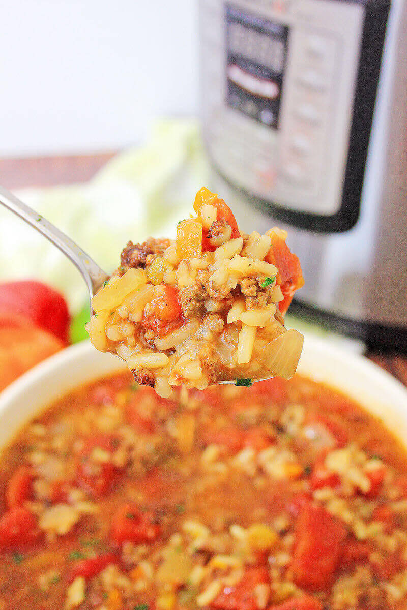 A spoonful of stuffed pepper soup in front of instant pot.