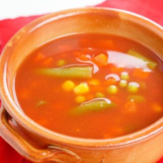 Orange bowl of vegetable soup.