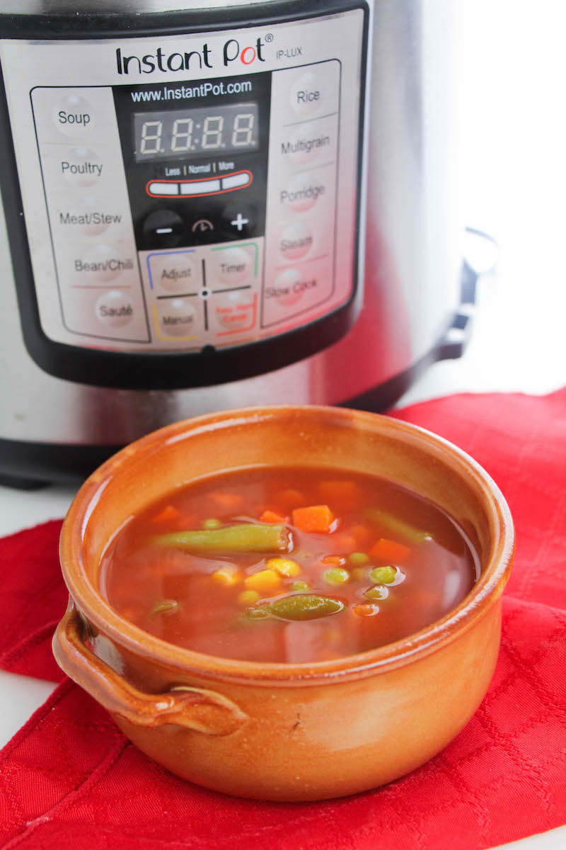 Bowl of vegetable soup in front of instant pot