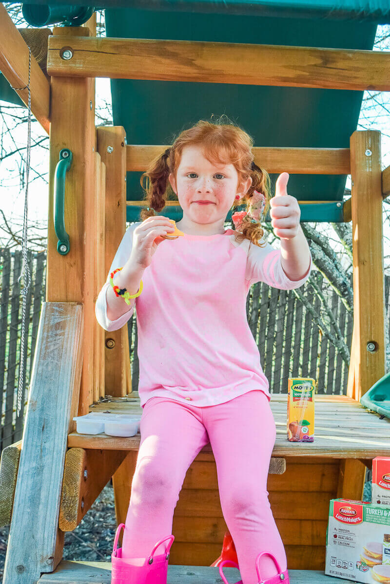 Little girl giving thumbs up.