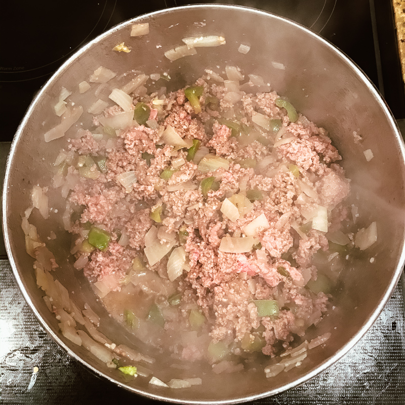 Ground beef browned in pot.