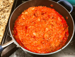 A pan of cooked sauce and beef.